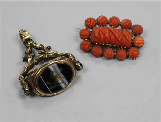 A gilt and chalcedony set spinning fob seal and coral brooch.